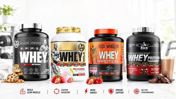 Four tubs of whey protein in cookies, strawberry and chocolate flavors displayed on a gym counter with dumbbells in the background